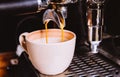 Close-up, Espresso pouring from making fresh coffee machine. Professional coffee shop. Vintage color tone Royalty Free Stock Photo