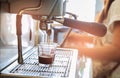 Close-up of espresso pouring to cup from coffee machine. Small b Royalty Free Stock Photo