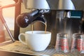 Close-up of espresso pouring to cup from coffee machine. Small b Royalty Free Stock Photo