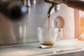 Close-up of espresso pouring to cup from coffee machine. Small b Royalty Free Stock Photo