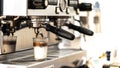 Close-up of espresso top white milk pouring from automatic coffee machine. Professional coffee brewing Royalty Free Stock Photo