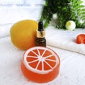 Close up essential oil bottle with citrus soap on white wooden background Royalty Free Stock Photo