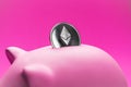 Close-up of ether physical coin in pink piggy bank with some copy space