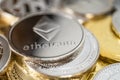 Close-up of ether physical coin on stack of many other cryptocurrencies