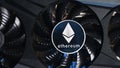 Close up of Ethereum coin on a black grafic video card. Cryptocurrency business device. Ethereum miners