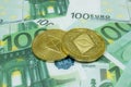 Close-up of 2 Ethereum coins on 100 Euro banknotes. Crypto currency ETC
