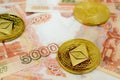 Close-up of Ethereum coins on 5000 Russian rubles banknote. Crypto currency ETC