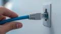 Close-Up of Ethernet Cable Plugging into Wall Royalty Free Stock Photo