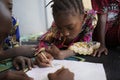 Close up of Ethnic African Children Drawing and Writing