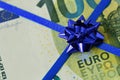 Close-up of euro banknote with bow - Concept of donating money