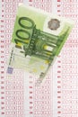 Close up of 100 euro note and betting slip Royalty Free Stock Photo
