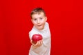 Caucasian boy kid child schoolboy apple gives in front red in his hands Royalty Free Stock Photo