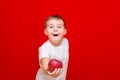 Caucasian boy kid child schoolboy apple gives in front red in his hands Royalty Free Stock Photo