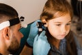 Close-up examination of childs ear with otoscope. Otoscopy. Visit to ENT doctor and consultation. Royalty Free Stock Photo