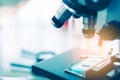 Close up of examining of test sample under the microscope in laboratory