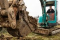 Close up of excavator or digger digging some soil or clay, industrial concept