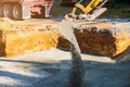 Close up excavator working on a construction site, excavator bucket levels gravel on the building foundation Royalty Free Stock Photo