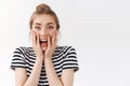 Close-up excited, amused good-looking woman with messy bun, striped t-shirt, scream from excitement and amazement react