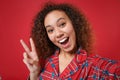 Close up of excited young african american girl in pajamas homewear rest at home isolated on red background. Relax good Royalty Free Stock Photo