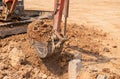 Close up excuvator digging a trench for foundation pile