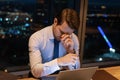 Close up exhausted sleepy businessman using laptop, working at night Royalty Free Stock Photo