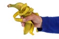 Diet concept with a banana surrounded by a flexible tape measure held in hand close-up on a white background Royalty Free Stock Photo