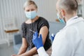 experienced doctor is preparing to vaccinate a patient.