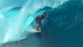 CLOSE UP: Experienced male surfer gets almost swept by a large barrel wave. Royalty Free Stock Photo