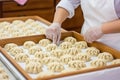 Close-up of expert hands skillfully making delicious dumplings for sale