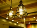 Close up of yellow light bulbs in metal cages