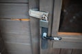 Close-up of exterior padlock and old handle of wooden door Royalty Free Stock Photo