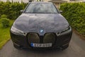 Close up exterior view of electric car BMW iX40 on parking spot.