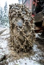 Close-up for extreme big off road 4x4 vehicle wheel with a snow and mud chains.. Extreme off-road 4x4 vehicle with snow and mud Royalty Free Stock Photo