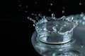 Close up, extreme macro. High speed photography. A drop of water when it strikes the surface of the disk forms a crown. Royalty Free Stock Photo