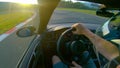 CLOSE UP: Extreme racer preparing for a race by driving around the raceway.