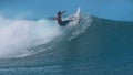 CLOSE UP: Extreme surfer carves a big tube wave breaking towards the sunny shore Royalty Free Stock Photo