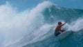 CLOSE UP: Extreme surfer spraying glassy water while carving a breaking wave.