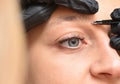 Close-up eye and eyebrow of young woman and eyebrow correction procedure. Royalty Free Stock Photo