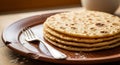Stacked warm flatbreads with a fork on a rustic brown plate, close-up shot Royalty Free Stock Photo