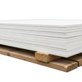 Stack Of White Rectangular Boards On Wooden Pallet Isolated On White Background panels sheets Royalty Free Stock Photo