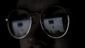 Close up of the eyes of a man with glasses at the computer isolated on black background. Concept. The reflection of the Royalty Free Stock Photo