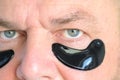 Close up on the eyes of a man wearing hydrating gel patches Royalty Free Stock Photo