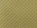 Close-up of fabric with embossed convex print. Bulging diamonds on yellow microfiber or dishwashing sponge. Background and free