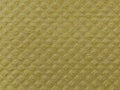 Close-up of fabric with embossed convex print. Bulging diamonds on yellow microfiber or dishwashing sponge. Background and free