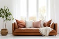 Close up of fabric sofa with terra cotta pillow against window and white wall. Scandinavian home interior design of modern room. Royalty Free Stock Photo