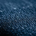 Close-up of a fabric surface with a woven pattern, displaying interlocking threads. The Royalty Free Stock Photo