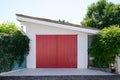 Close up on facade view of red classic garage wooden door