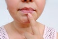 Close-up face, adult middle-aged woman 50 years old looking at her dry lips, age wrinkles, aging problems, concept of female age,