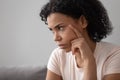 Closeup african pensive woman sit indoors feels discontented having problems Royalty Free Stock Photo