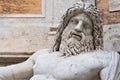 Close-up on face of ancient roman statue representing Neptune